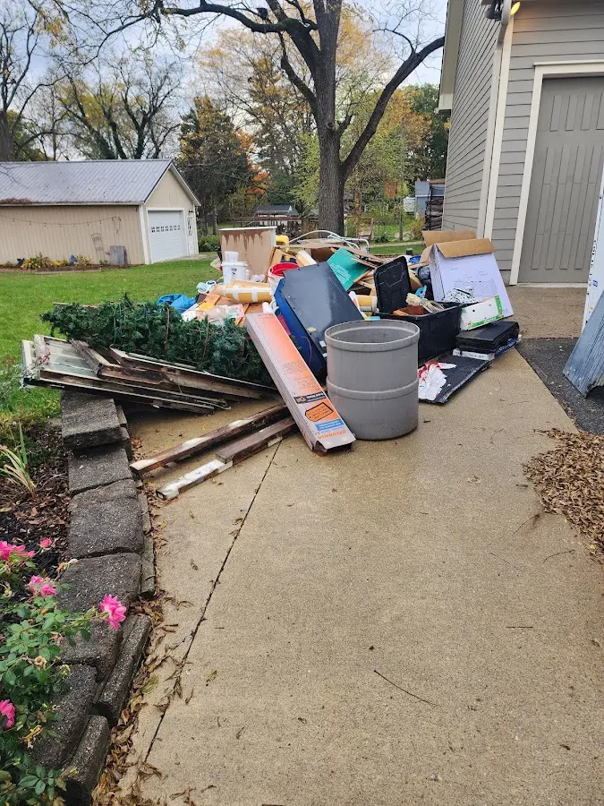 Dumpster being loaded with debris for Commercial Dumpster Rental in La Vista